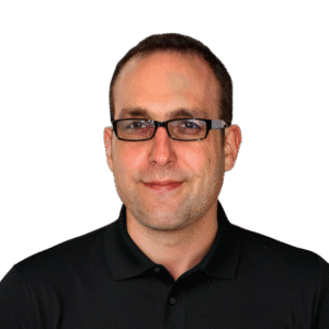 Portrait of a man with glasses wearing a black polo shirt against a green background.